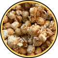 Close-up of Fisher's Popcorn Caramel inside a circular yellow and black frame, displaying glossy, evenly coated popcorn pieces—ideal for a small tub or as part of a caramel bundle.