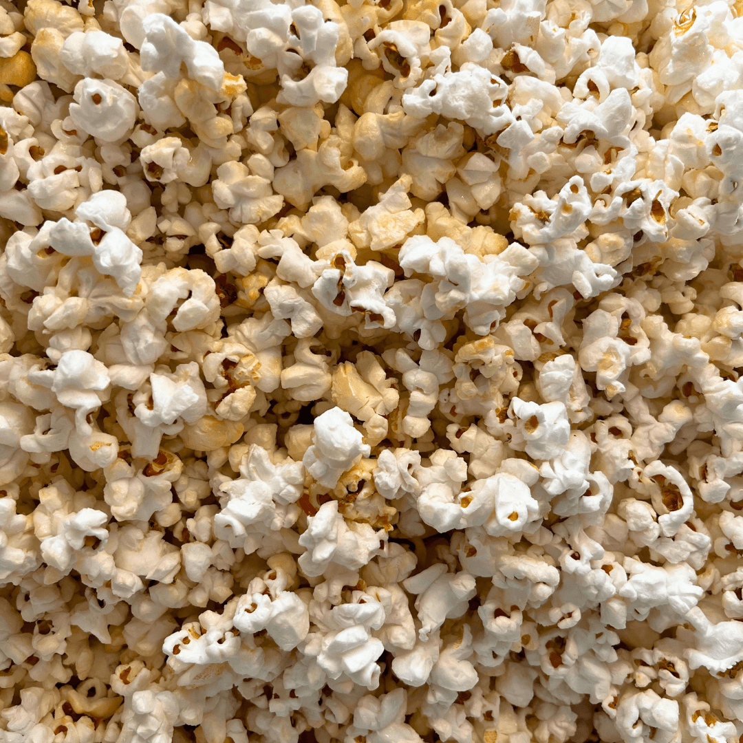 A close-up of fluffy, freshly popped white and golden yellow kernels, capturing the classic taste of Fisher's Popcorn Tubs by Fisher’s Popcorn.