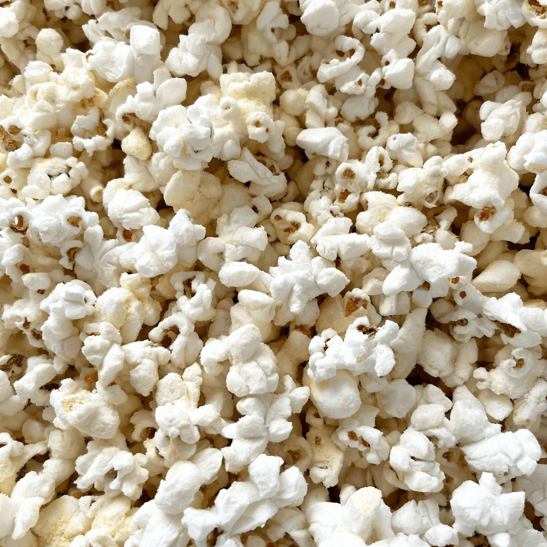 A close-up of fluffy, white popped kernels with hints of golden brown—just like the irresistible original caramel popcorn in Fisher’s Popcorn Tubs from Fisher's Popcorn.