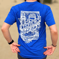 Someone wears the Fisher's Popcorn Fisher's T-Shirt in bright blue, featuring a white lighthouse, popcorn bucket, waves, and text: “Fisher’s Popcorn, Fenwick Island, Boardwalk, Beach”—a perfect beach tee for popcorn fans.
