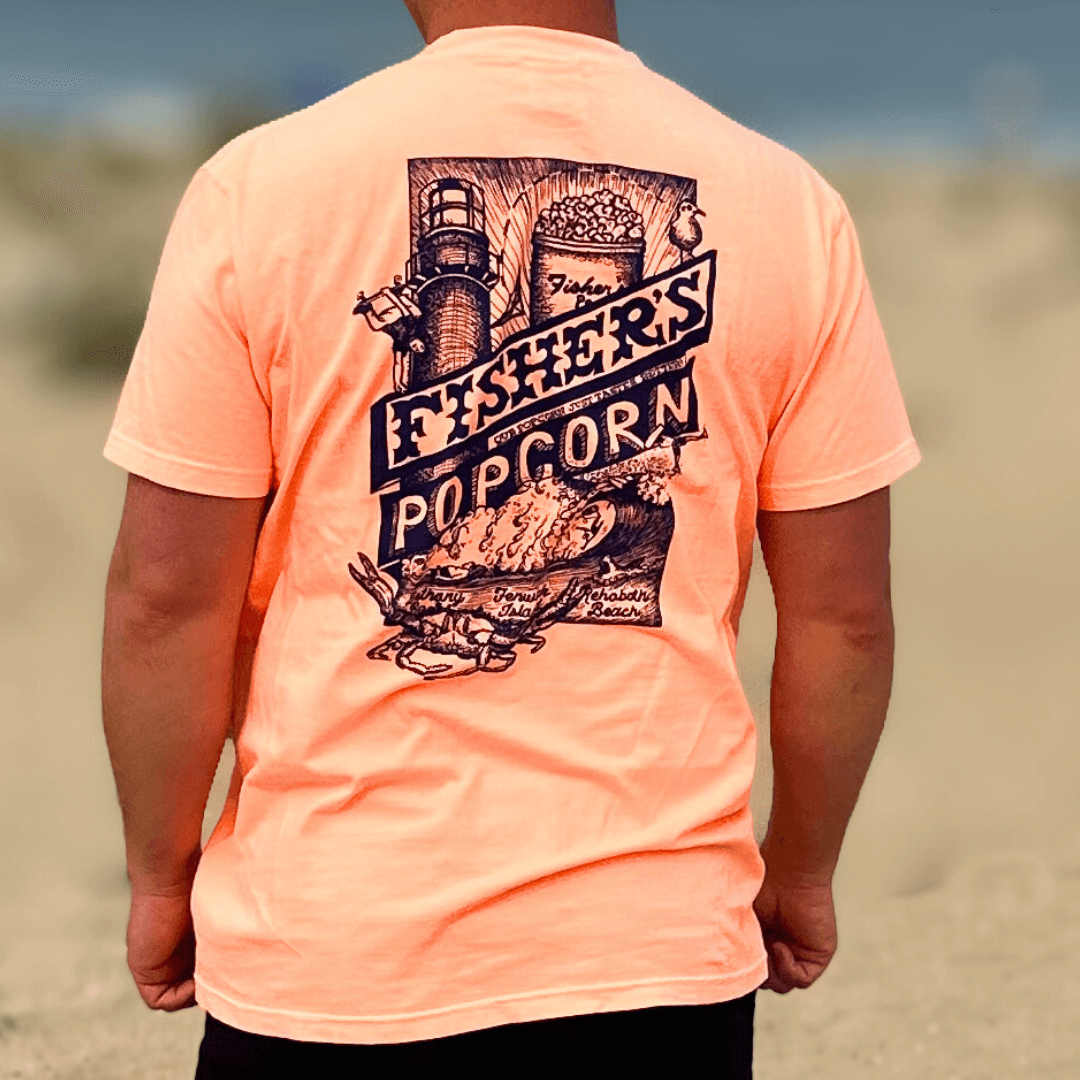 Wearing the Fisher's T-Shirt by Fisher's Popcorn, with a bold back graphic of popcorn, a lighthouse, and coastal scenery—ideal for popcorn fans who want to stand out on the beach.
