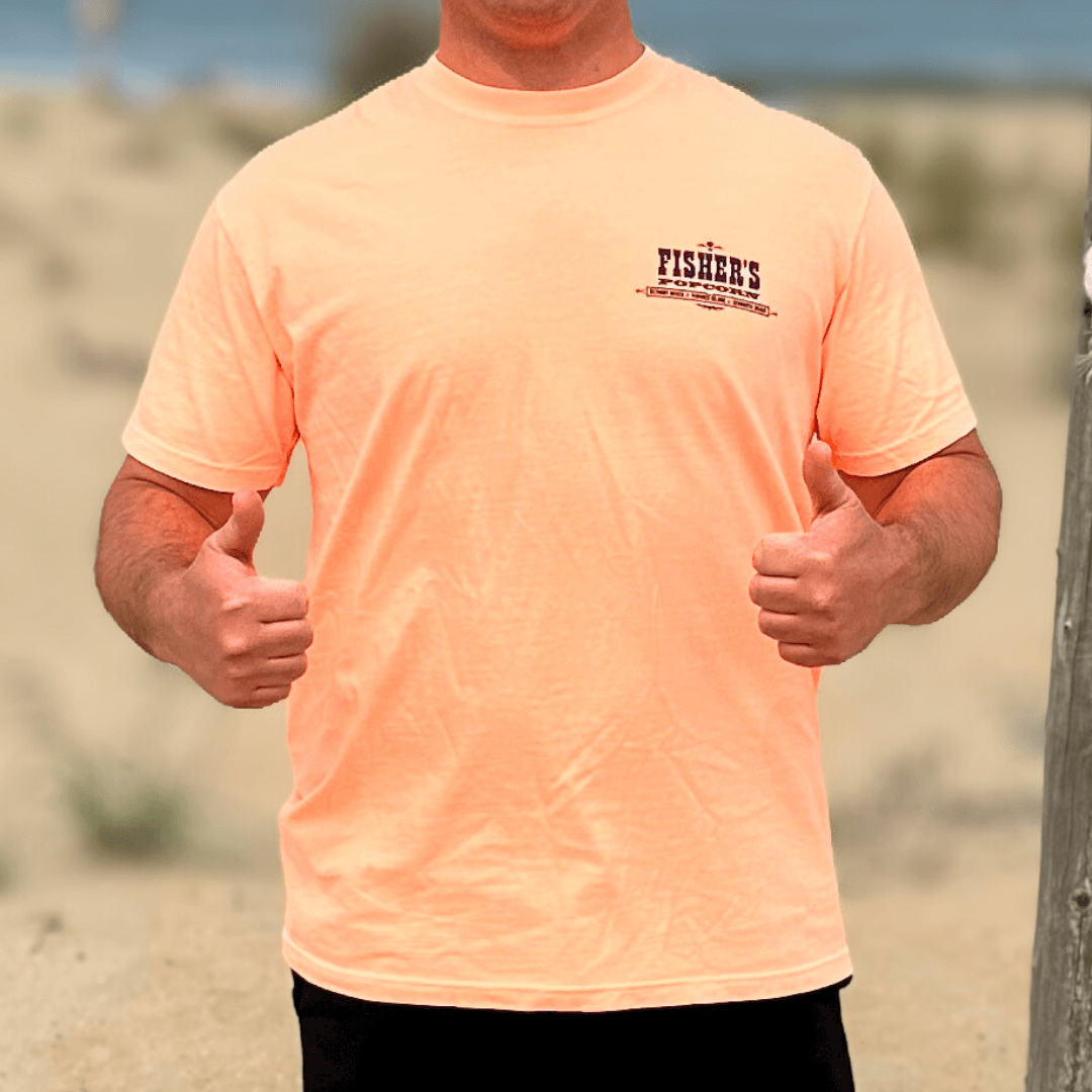 A person on a sandy beach gives two thumbs up, wearing a light orange Fisher's Popcorn Fisher's T-Shirt with the logo on the left chest. Their head isn't visible—ideal for popcorn fans at the shore.