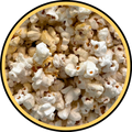 A close-up image of Fisher's Popcorn Kettle Corn, showing lightly browned popped kernels inside a circular yellow and black border.