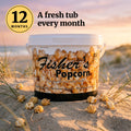 Popcorn of the Month Club, 12 months: a Fisher's Popcorn caramel tub on a Delaware beach dune at sunset
